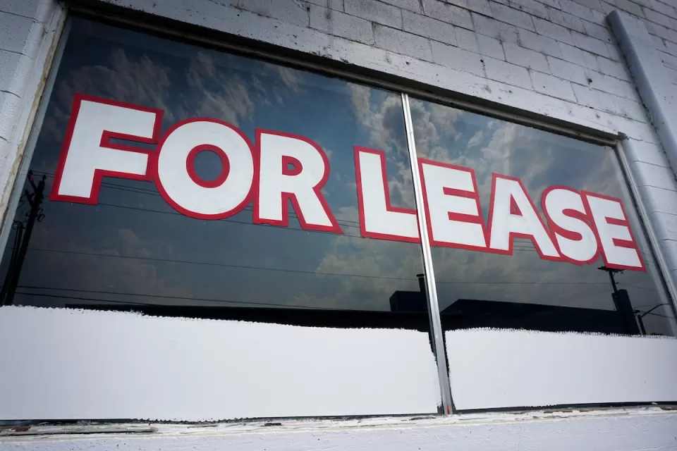 For Lease painted on window of vacant commercial space.